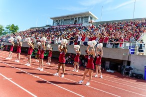 Cheer team at football game cheering